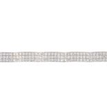 A diamond bracelet. Designed as three brilliant-cut diamond lines, with polished bar spacers and