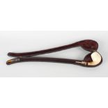 A churchwardens pipe, the meerschaum bowl upon a long yellow metal and silver banded stem with amber