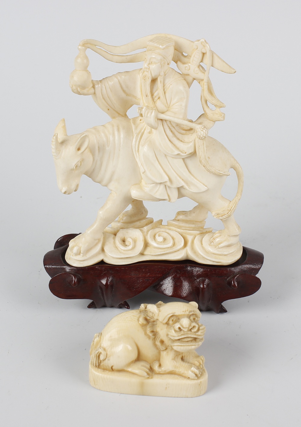 A Japanese carved ivory okimono, late Meiji/Taisho period, modelled as a sage riding upon a mythical