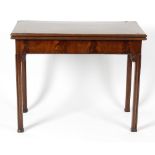 A 19th century Chippendale Revival mahogany fold-over card table. The rectangular top enclosing a