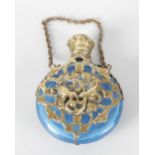 A Victorian circular blue glass bodied scent bottle with hinged cover and fitted suspension chain,