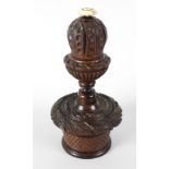 An early 19th century carved and stained wooden table nutmeg grater, the sectional body united by