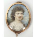 A 19th century oval head and shoulder portrait miniature upon ivory panel, depicting a young girl,