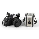 A box containing a Canon T50 35mm camera, Kodak Duaflex camera, Samsung AF slim 200m 35mm camera,