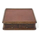 An oak tabletop cabinet with cloth top, c.1900, one side having four rectangular drawers with