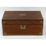 A late Victorian brass-bound figured walnut lap desk. The hinged rectangular cover centred by an