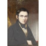 A 19th century painted portrait upon ivory panel, half length study of a young gentleman seated in a