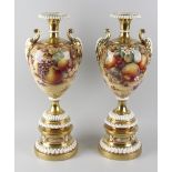 A fine large pair of Royal Worcester porcelain vases, each of baluster form having waisted neck