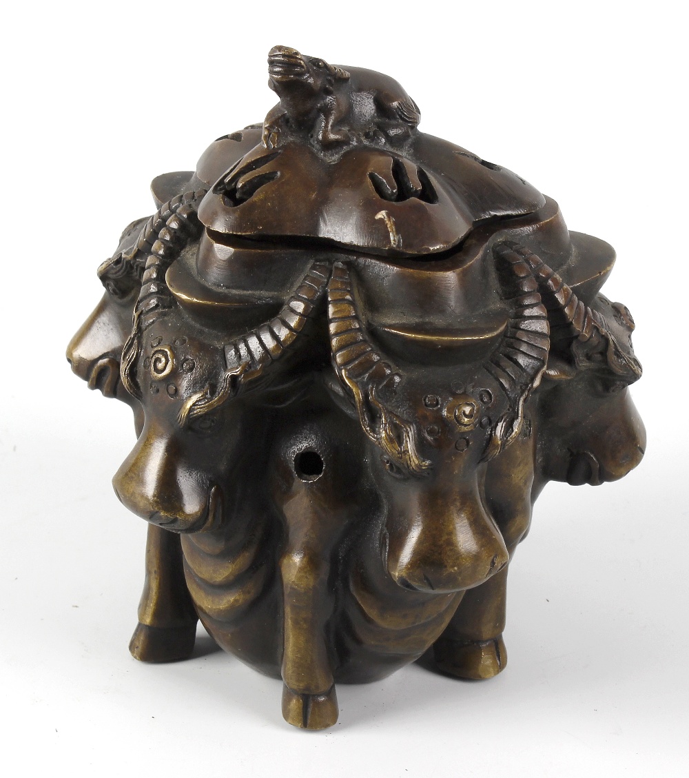 A Sino-Tibetan bronze incense burner and cover, the body modelled as five horned bulls facing