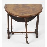 A small mid Victorian walnut Sutherland table. The top and oval flaps with figured border and