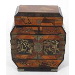An early 20th century oriental parquetry and lacquered table top cabinet, the hinged opening top