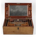 A Regency mahogany dressing box. The hinged rectangular cover with strung edges, enclosing a