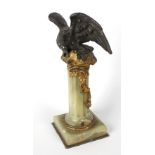 A 19th century bronze and gilt bronze pocket watch stand, modelled as an eagle with outstretched