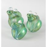 A graduated set of three John Ditchfield Glasform frog paperweights, each of iridescent green