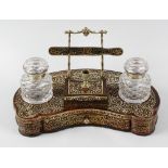 A 19th century red boulle desk stand, the body of kidney shaped form, with lower drawer, two glass