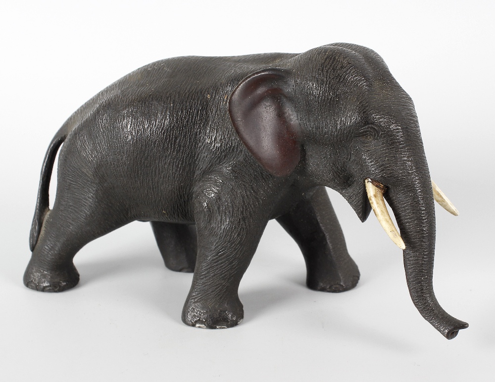 A Japanese Meiji period bronze study of an elephant with inset ivory tusks, 7 (17.75cm) long, 4 (
