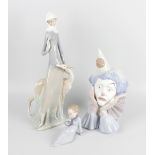 A group of four Lladro figurines, the first example modelled as the bust of a sad clown resting