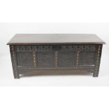 A 17th century and later inlaid oak coffer, the later four-plank hinged lid with moulded edge, the