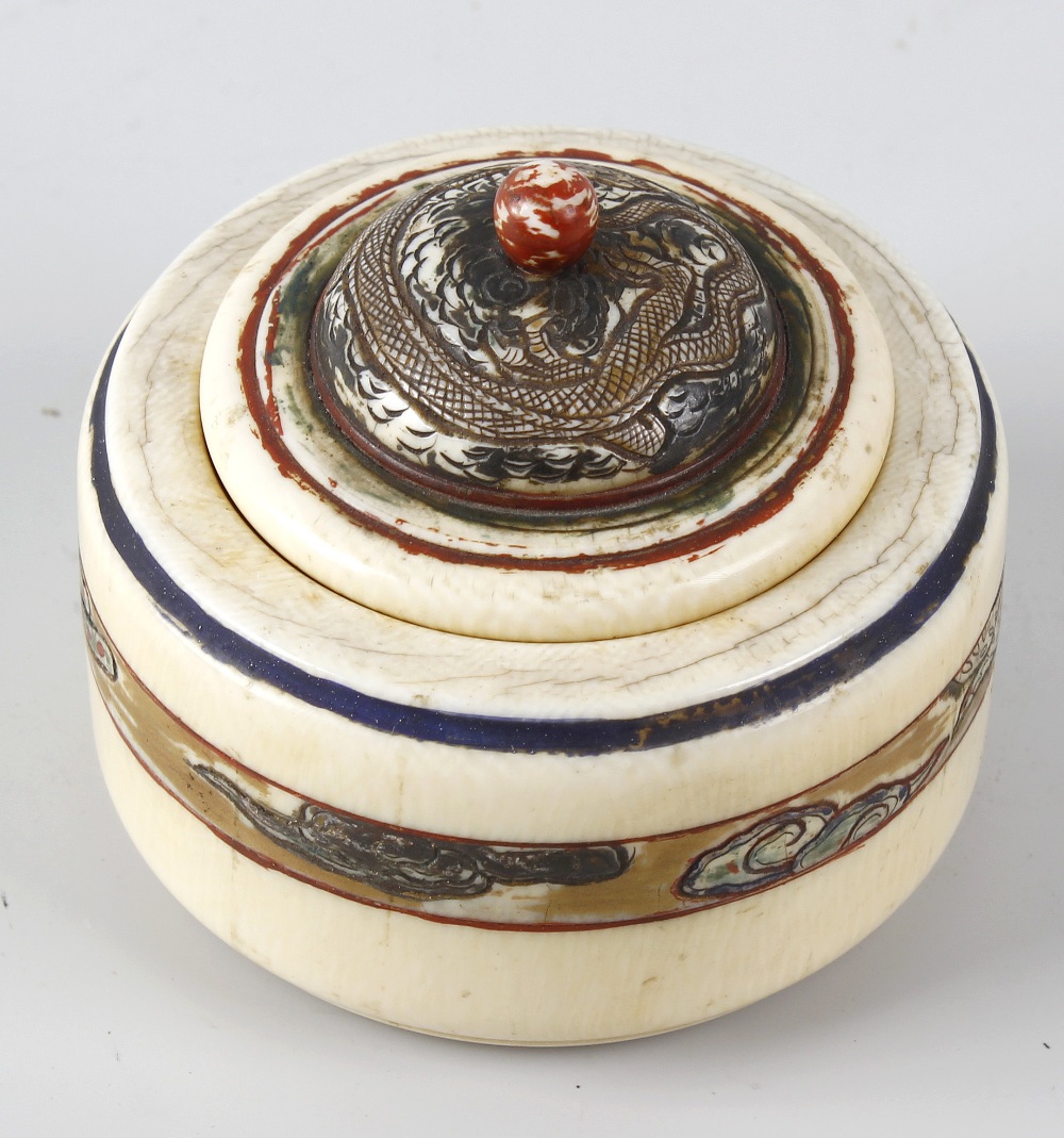 A Chinese ivory box and cover, of circular form with stepped domed cover, having etched and