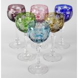 A set of six cut wine glasses, each having hobnail cut panels to the glass bowls of varying