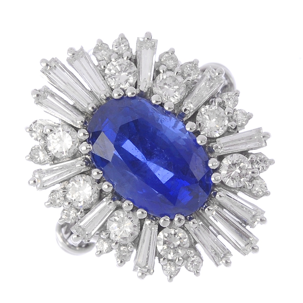 An 18ct gold Burmese sapphire and diamond cocktail ring. The oval-shape sapphire, with alternating