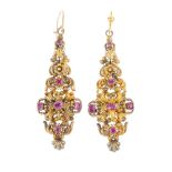A pair of late Georgian gold foil-back ruby earrings. Each designed as a tapered, floral and