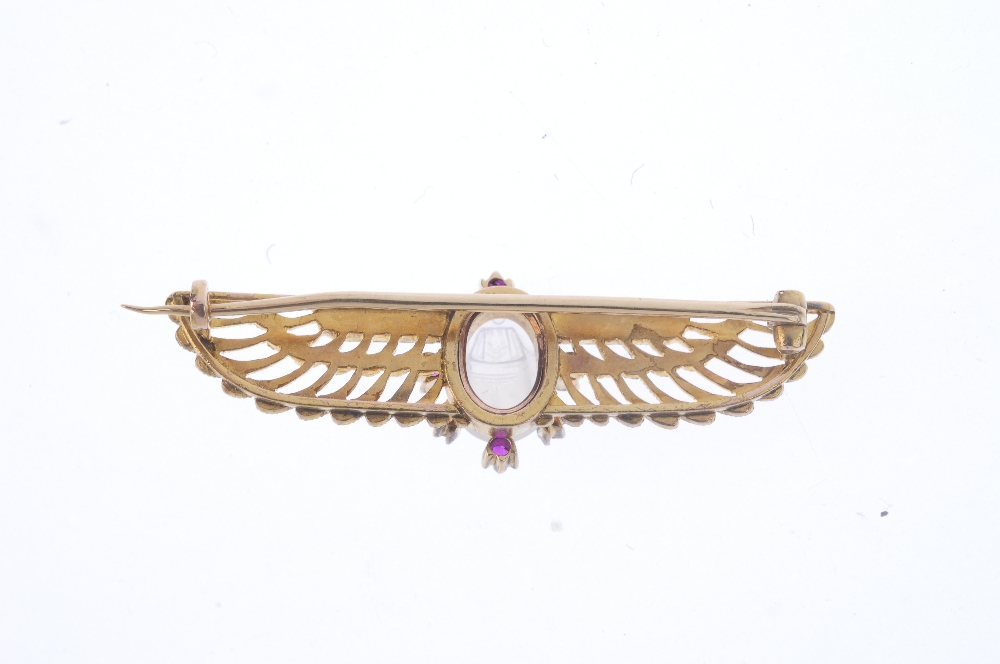 An early 20th century Egyptian Revival gold, diamond and gem-set brooch. The carved moonstone scarab - Image 2 of 2