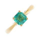 An 18ct gold Colombian emerald single-stone ring. The rectangular-shape Colombian emerald, with