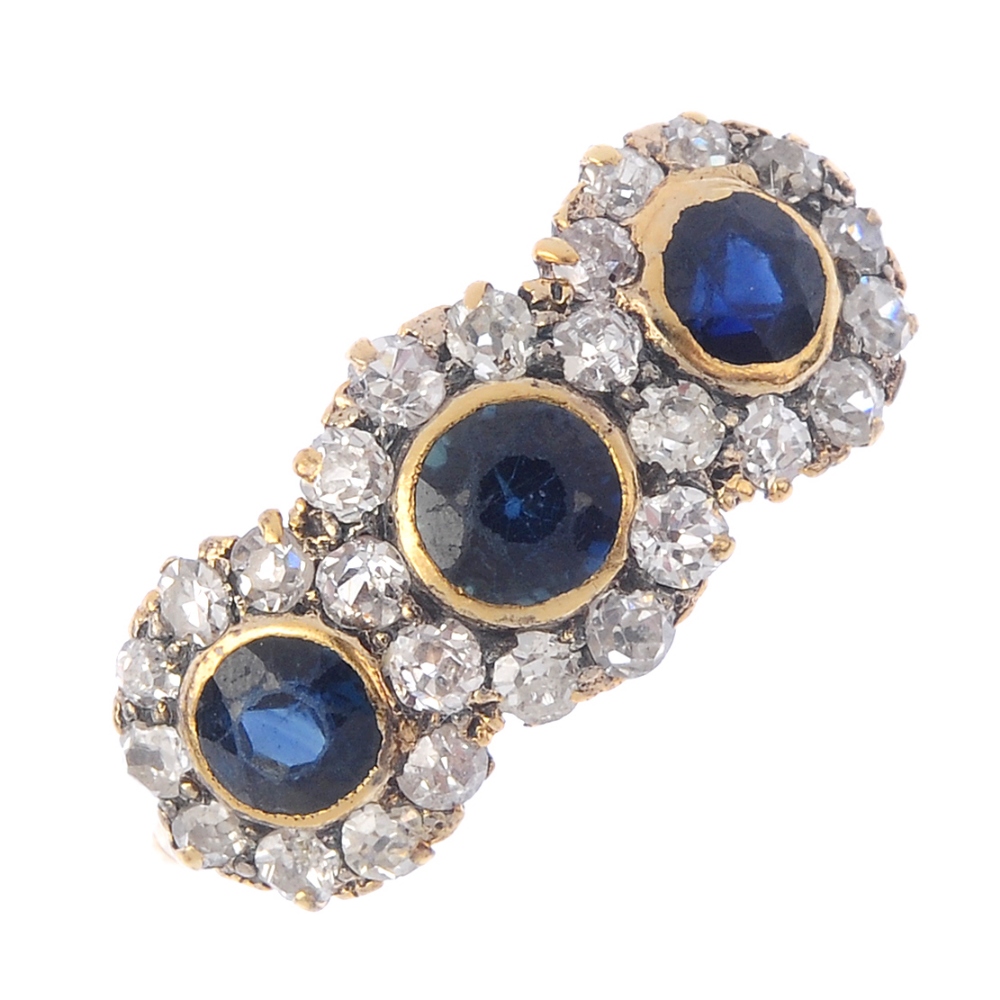 A mid 20th century 18ct gold sapphire and diamond triple cluster ring. Comprising three slightly