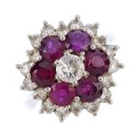 A ruby and diamond cluster ring. The brilliant-cut diamond, within a circular-shape ruby and