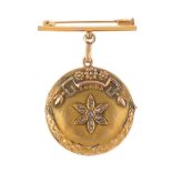 An Edwardian gold diamond locket. Of circular-outline, the textured locket, with rose-cut diamond