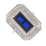 A sapphire and diamond cluster ring. The rectangular-shape sapphire, with single-cut diamond