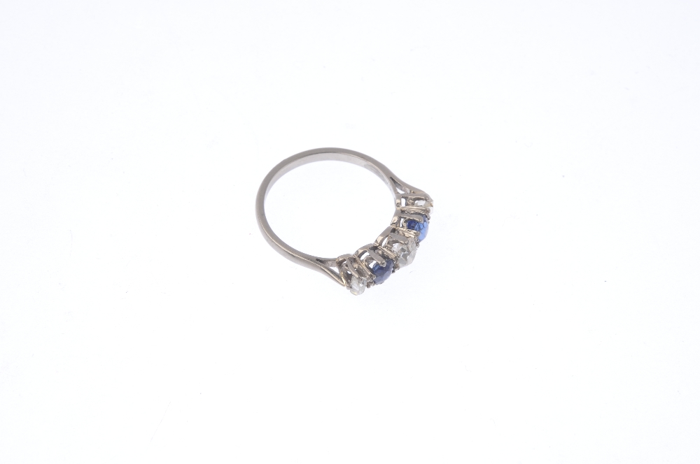 A mid 20th century diamond and sapphire five-stone ring. The alternating graduated old-cut diamond - Image 4 of 4