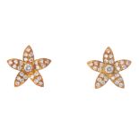 A pair of diamond floral earrings. Each designed as a brilliant-cut diamond collet, within a