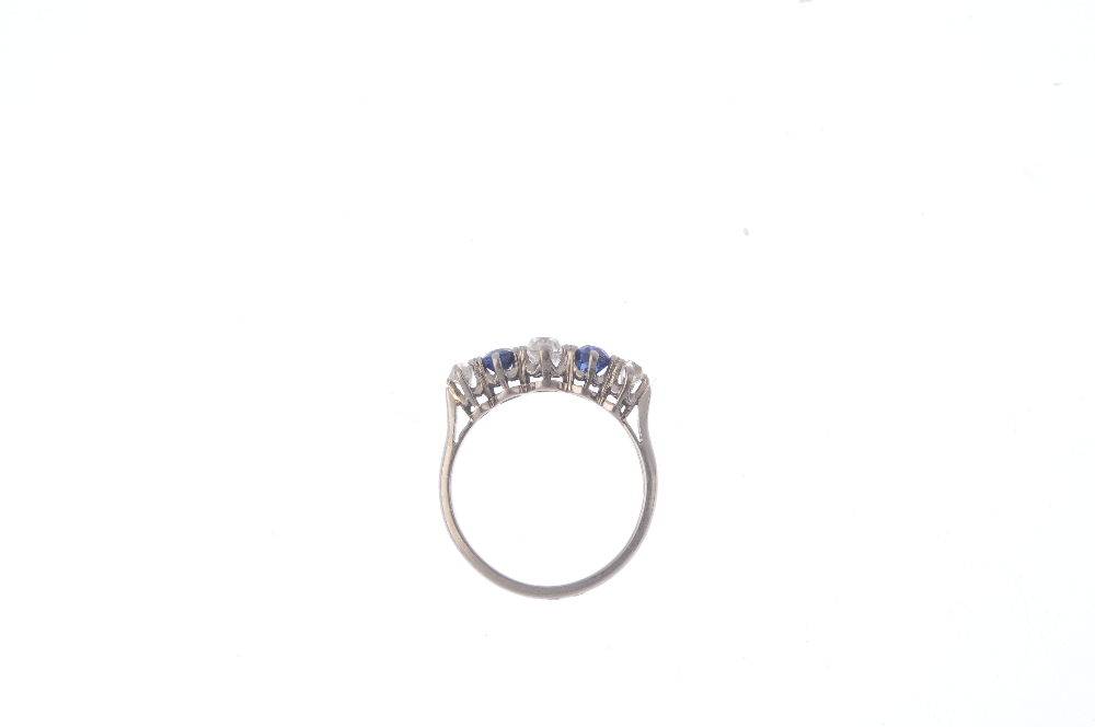 A mid 20th century diamond and sapphire five-stone ring. The alternating graduated old-cut diamond - Image 2 of 4