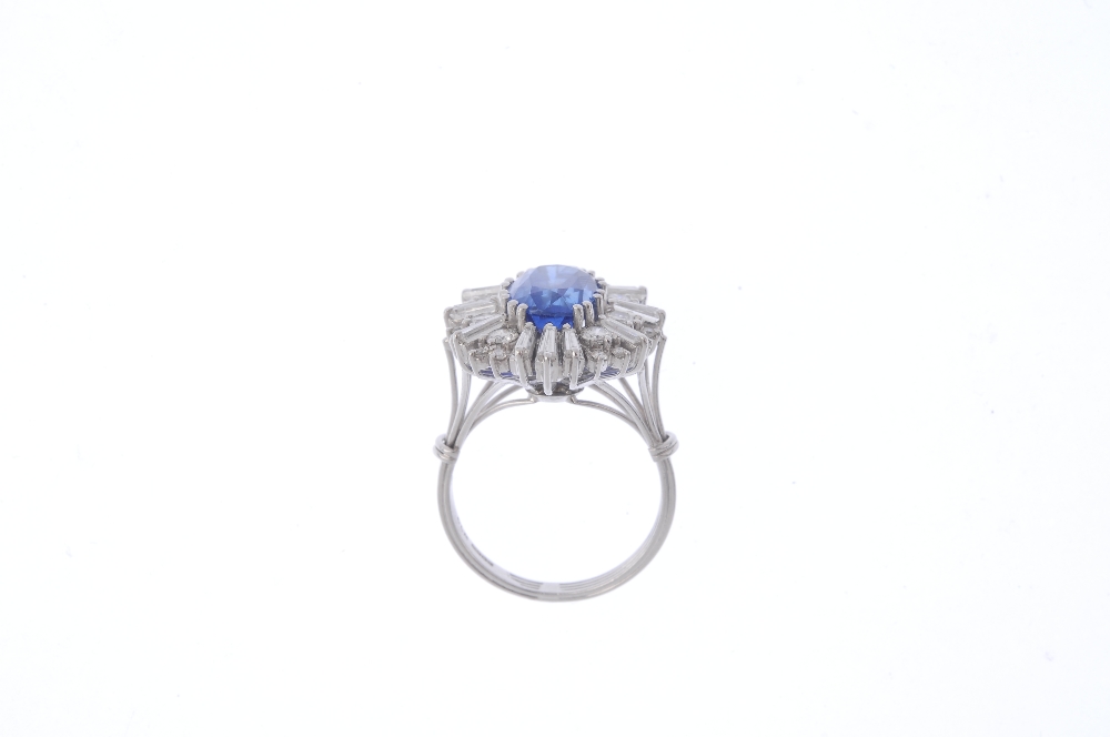 An 18ct gold Burmese sapphire and diamond cocktail ring. The oval-shape sapphire, with alternating - Image 2 of 4