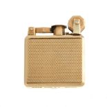 A 9ct gold lighter. Designed as a rectagular case, with engine turned design front and back and to
