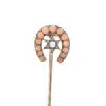 A late 19th century split pearl, diamond and coral horseshoe stickpin. Designed in the shape of an