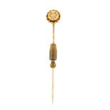 A late 19th century gold and diamond stickpin. The circular diamond set to a circular-shape