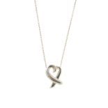 TIFFANY & CO. - a Paloma Picasso pendant. Designed as a crossed heart shape suspended from a fine