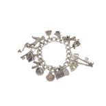 A charm bracelet. The curb-link chain with heart-shape padlock charm, suspending a total of