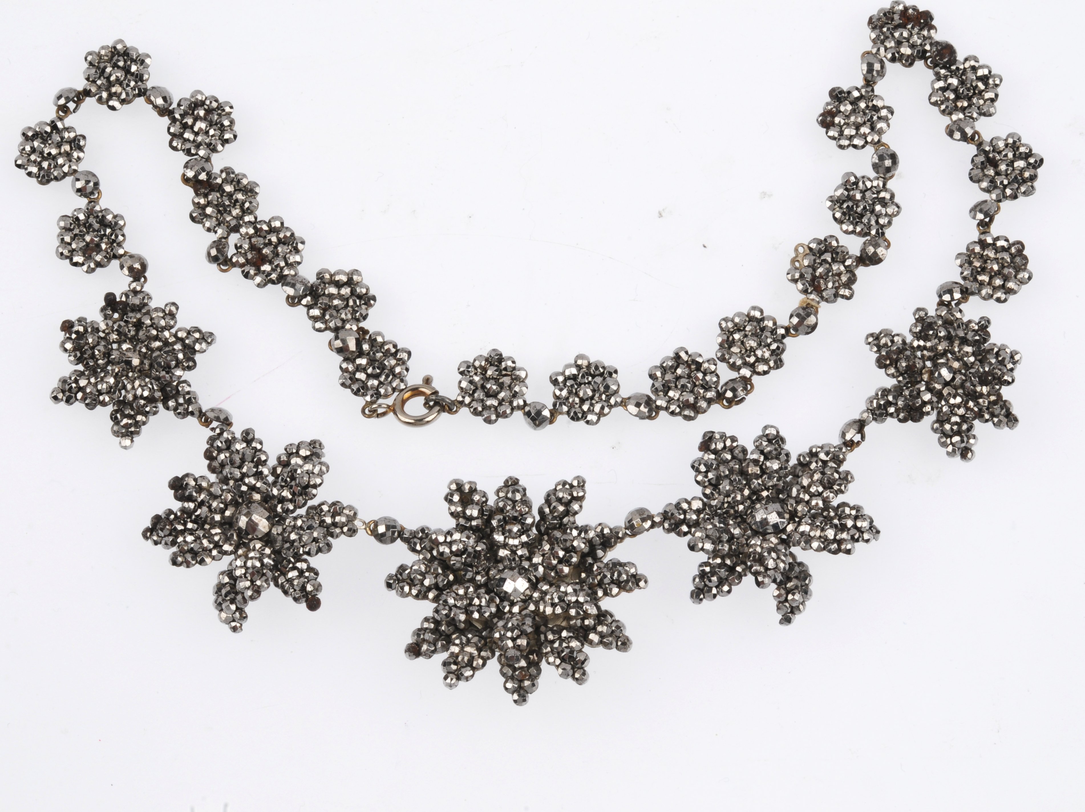 An early 19th century cut steel necklace. Designed as five cut steel flowers, with layered petal - Image 2 of 3