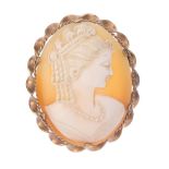 A gold shell cameo brooch and a silver 1970s hinged bangle. The cameo carved to depict a lady with