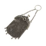 A mesh purse. With arched foliate embossed frame, bead drops to the bottom and a chain and hoop