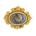 A mid Victorian gold split pearl memorial brooch. The oval arranged hair panel, within a split pearl