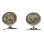 GEORG JENSEN - a pair of cufflinks. Of circular outline, depicting bulls in relief to both, to the