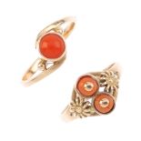 Two coral rings. The first a single circular coral cabochon, collet-set to asymmetric shoulders with