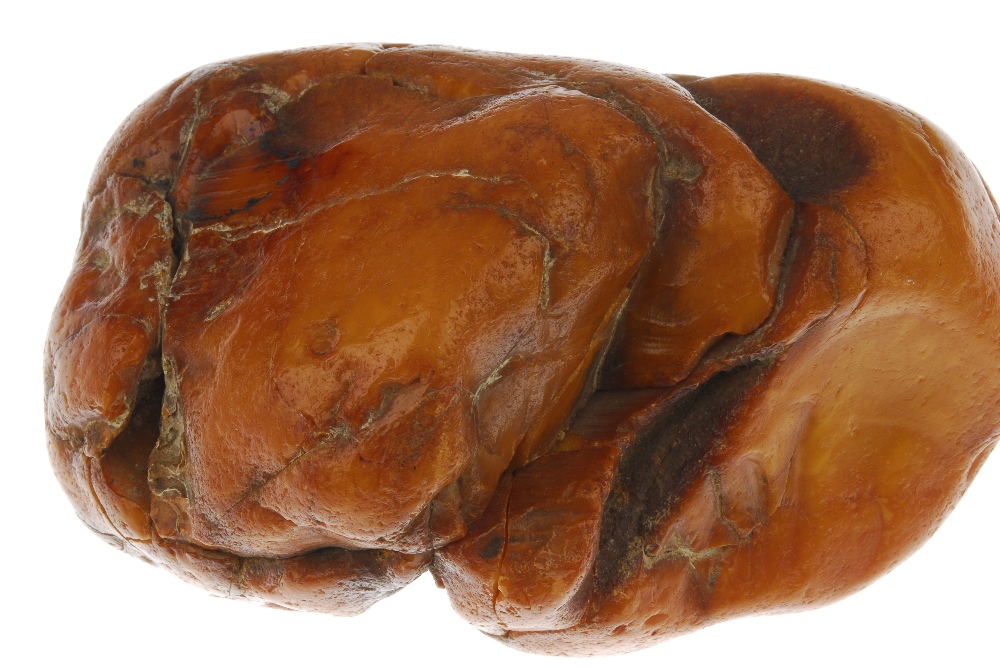 An amber boulder. The boulder of roughly oval shape with visible deep natural pits and fractures. - Image 4 of 4