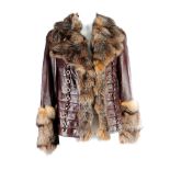 A leather jacket with fox fur collar and cuffs. Featuring a layered design with metal ring