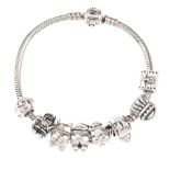 PANDORA - a bracelet. The snake-chain bracelet with eight Pandora charms, including a monkey and a